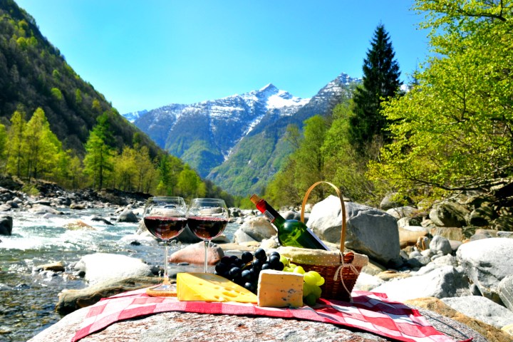 Grapes, cheese, and wine by mountain stream