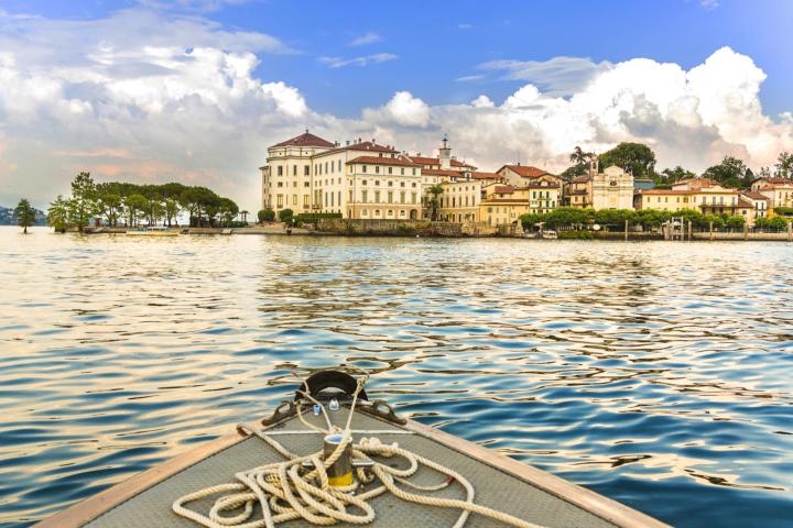 a bird sitting on a dock next to a body of water