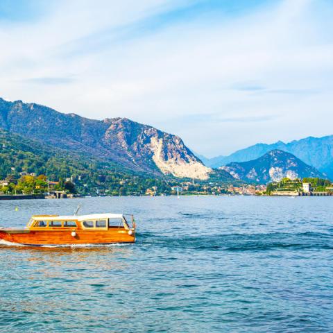 a small boat in a body of water with a mountain in the background