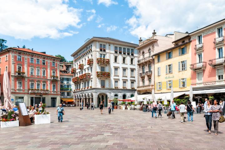 a group of people walking in front of a building