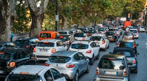 a car parked on a city street filled with lots of traffic